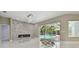 Modern living room with fireplace and view of pool area at 1460 Kensington Woods Dr, Lutz, FL 33549