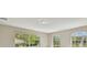 A bright living room features large windows overlooking a tranquil pond and lush greenery at 1460 Kensington Woods Dr, Lutz, FL 33549