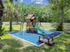 Backyard playground with a slide, climbing wall, and swing set, perfect for children at 1460 Kensington Woods Dr, Lutz, FL 33549