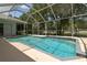 Serene screened in pool with clear blue water, surrounded by lush greenery at 1460 Kensington Woods Dr, Lutz, FL 33549