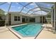 Beautiful screened-in pool surrounded by lush landscaping, providing a private oasis at 1460 Kensington Woods Dr, Lutz, FL 33549