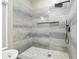 This walk-in shower features a modern rainfall shower head and beautiful tile and a built-in niche at 1460 Kensington Woods Dr, Lutz, FL 33549