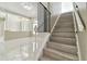 An interior staircase features tile flooring, elegant banisters, and views into the house at 1460 Kensington Woods Dr, Lutz, FL 33549
