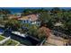 Waterfront home with dock access, surrounded by lush tropical landscaping and mature trees at 147 Bay Point Ne Dr, St Petersburg, FL 33704