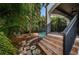 Brick stairs with wrought iron railing leading to a backyard with lush tropical landscaping and pool at 147 Bay Point Ne Dr, St Petersburg, FL 33704