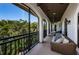Relaxing screened balcony with comfortable seating and a serene view of tropical foliage at 147 Bay Point Ne Dr, St Petersburg, FL 33704