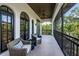 Inviting balcony with wicker chairs, a small table, and a ceiling fan, offering outdoor relaxation at 147 Bay Point Ne Dr, St Petersburg, FL 33704