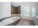 Relaxing bathroom with a large soaking tub and updated tile in neutral tones at 147 Bay Point Ne Dr, St Petersburg, FL 33704