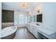 Spacious bathroom featuring dual sinks, marble countertops, custom vanity, and modern fixtures at 147 Bay Point Ne Dr, St Petersburg, FL 33704