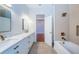 Bright bathroom featuring double vanity, marble countertop and herringbone tile at 147 Bay Point Ne Dr, St Petersburg, FL 33704