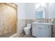 Elegant bathroom featuring a tiled shower, modern vanity, and decorative floor tiles at 147 Bay Point Ne Dr, St Petersburg, FL 33704