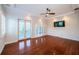 Bright bedroom with hardwood floors, plantation shutters, and french doors leading to a balcony at 147 Bay Point Ne Dr, St Petersburg, FL 33704