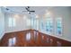 Spacious bedroom with hardwood floors, tray ceiling, and multiple windows, offering natural light at 147 Bay Point Ne Dr, St Petersburg, FL 33704