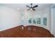 Inviting bedroom featuring hardwood floors, ceiling fan, and abundant natural light at 147 Bay Point Ne Dr, St Petersburg, FL 33704