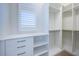 Bright walk-in closet boasts custom shelving, drawers, and ample hanging space for storage at 147 Bay Point Ne Dr, St Petersburg, FL 33704