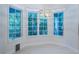 Open dining area bathed in natural light from ample windows with backyard views and a stylish chandelier at 147 Bay Point Ne Dr, St Petersburg, FL 33704
