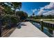 Residential waterfront view of a private dock in a canal setting at 147 Bay Point Ne Dr, St Petersburg, FL 33704