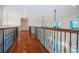 Hallway featuring hardwood floors, iron railings and arched windows at 147 Bay Point Ne Dr, St Petersburg, FL 33704
