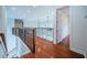 Bright hallway boasting wood flooring, decorative railing, and recessed lighting at 147 Bay Point Ne Dr, St Petersburg, FL 33704