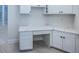Bright home office features white cabinetry, quartz counters, and durable tile flooring at 147 Bay Point Ne Dr, St Petersburg, FL 33704