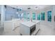 Modern kitchen featuring white cabinets, quartz countertops and backsplash, stainless steel appliances and tile floors at 147 Bay Point Ne Dr, St Petersburg, FL 33704