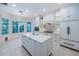 Bright kitchen featuring a center island, stainless steel appliances, and large windows at 147 Bay Point Ne Dr, St Petersburg, FL 33704