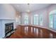 Bright living room showcasing a fireplace, hardwood floors and arched windows at 147 Bay Point Ne Dr, St Petersburg, FL 33704