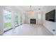 Bright living room featuring a fireplace, light neutral paint, recessed lighting, and plenty of windows at 147 Bay Point Ne Dr, St Petersburg, FL 33704