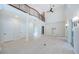 Spacious living room featuring tile floors and high ceilings with an upstairs loft, and an open floor plan at 147 Bay Point Ne Dr, St Petersburg, FL 33704