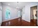 Bright living room boasting hardwood floors, built-in shelving, and plantation shutters at 147 Bay Point Ne Dr, St Petersburg, FL 33704