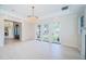 Light-filled living room with tile floors, custom trim, French doors, and a partial view to another room at 147 Bay Point Ne Dr, St Petersburg, FL 33704