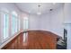 Spacious living room showcasing hardwood floors, fireplace, and arched windows at 147 Bay Point Ne Dr, St Petersburg, FL 33704