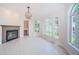 Open living room with a fireplace, detailed trim, tile flooring, and plenty of natural light from large windows at 147 Bay Point Ne Dr, St Petersburg, FL 33704