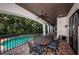 Outdoor dining set on a covered patio with a ceiling fan, stone floors, overlooking a refreshing pool at 147 Bay Point Ne Dr, St Petersburg, FL 33704