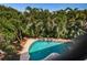 Refreshing swimming pool surrounded by lush landscaping, creating a private oasis at 147 Bay Point Ne Dr, St Petersburg, FL 33704