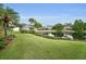Manicured backyard with pond and lush landscaping creates a tranquil view at 1528 Riverdale Dr, Oldsmar, FL 34677