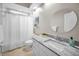 Bathroom with granite countertops, white cabinets, and a shower-tub combo at 1528 Riverdale Dr, Oldsmar, FL 34677