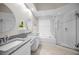 Bright bathroom features a double vanity, soaking tub, and glass-enclosed shower at 1528 Riverdale Dr, Oldsmar, FL 34677