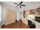 Office/Bedroom with built-in desk, wood floors, and ample cabinet space at 1528 Riverdale Dr, Oldsmar, FL 34677