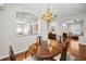 Elegant dining room area with hardwood floors and views of the living spaces at 1528 Riverdale Dr, Oldsmar, FL 34677