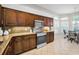 Well-lit kitchen with granite countertops, stainless steel appliances, and a breakfast nook at 1528 Riverdale Dr, Oldsmar, FL 34677