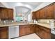 Stylish kitchen featuring dark wood cabinets, granite countertops, and stainless steel appliances at 1528 Riverdale Dr, Oldsmar, FL 34677