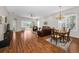 Bright living room featuring hardwood floors and sliding glass doors leading to the lanai at 1528 Riverdale Dr, Oldsmar, FL 34677