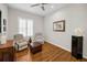 Inviting living room with two armchairs, hardwood floors, and a ceiling fan at 1528 Riverdale Dr, Oldsmar, FL 34677