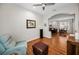 Open-concept living room with a leather sofa, hardwood floors, and an archway at 1528 Riverdale Dr, Oldsmar, FL 34677