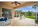 Covered and screened patio features a ceiling fan, seating and views of the pond at 1528 Riverdale Dr, Oldsmar, FL 34677