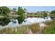 The pond reflects the homes along the water's edge at 1528 Riverdale Dr, Oldsmar, FL 34677