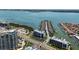 Stunning aerial view showcases waterfront condos with private boat docks, tennis courts, and bay views at 1581 Gulf Blvd # 403N, Clearwater Beach, FL 33767