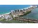 Breathtaking aerial view showcasing the coastal community, oceanfront condos, and nearby waterways with boat docks at 1581 Gulf Blvd # 403N, Clearwater Beach, FL 33767