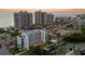 An aerial view showcases this waterfront condo community's pool, tennis courts, boat slips, and beach access at 1581 Gulf Blvd # 403N, Clearwater Beach, FL 33767
